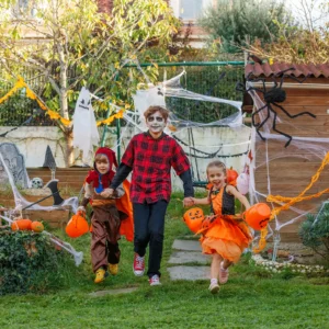 A family having fun trick-or-treating on a dog poop free yard on Halloween.